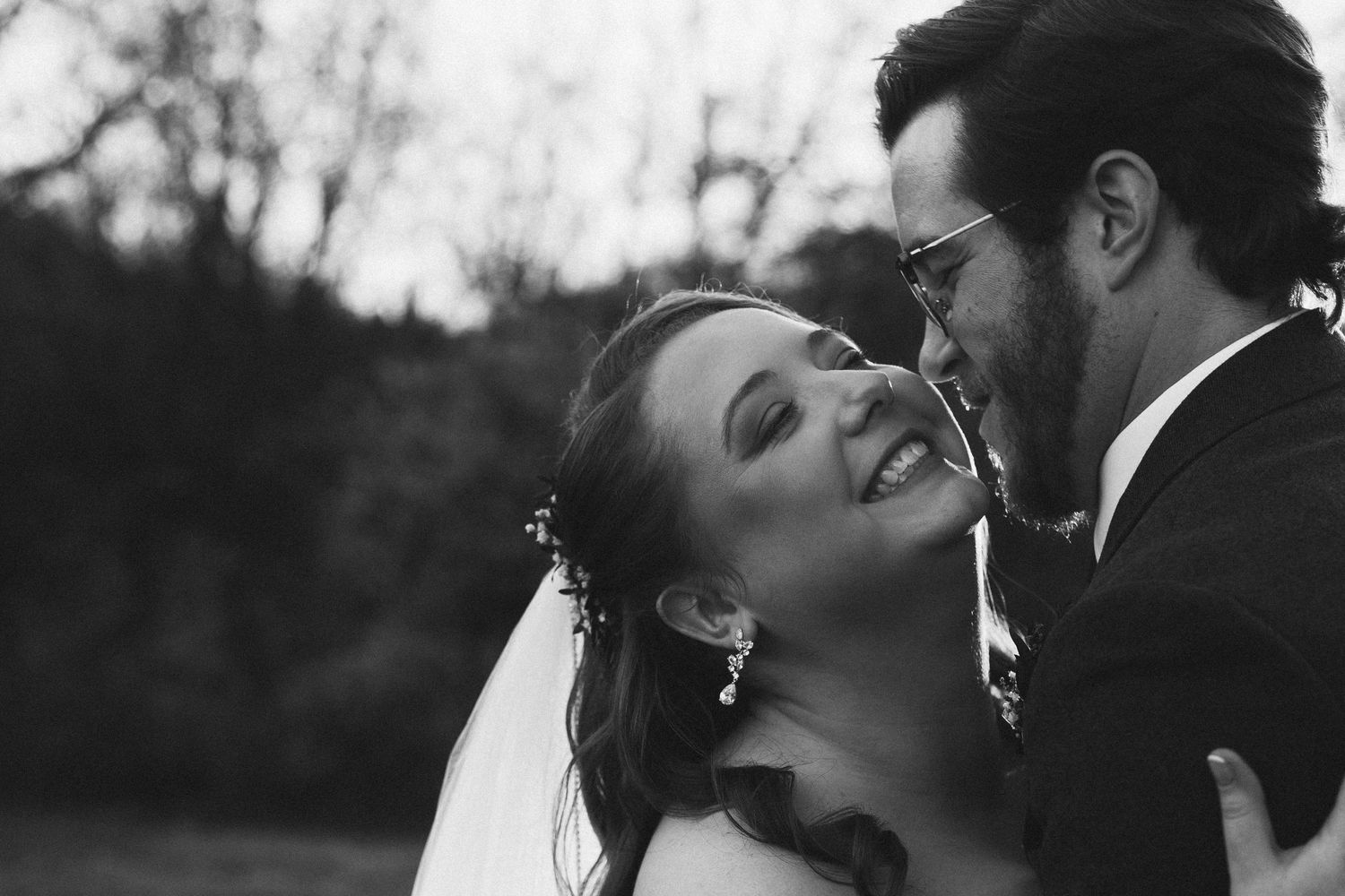Intimate black and white wedding portrait outdoors.