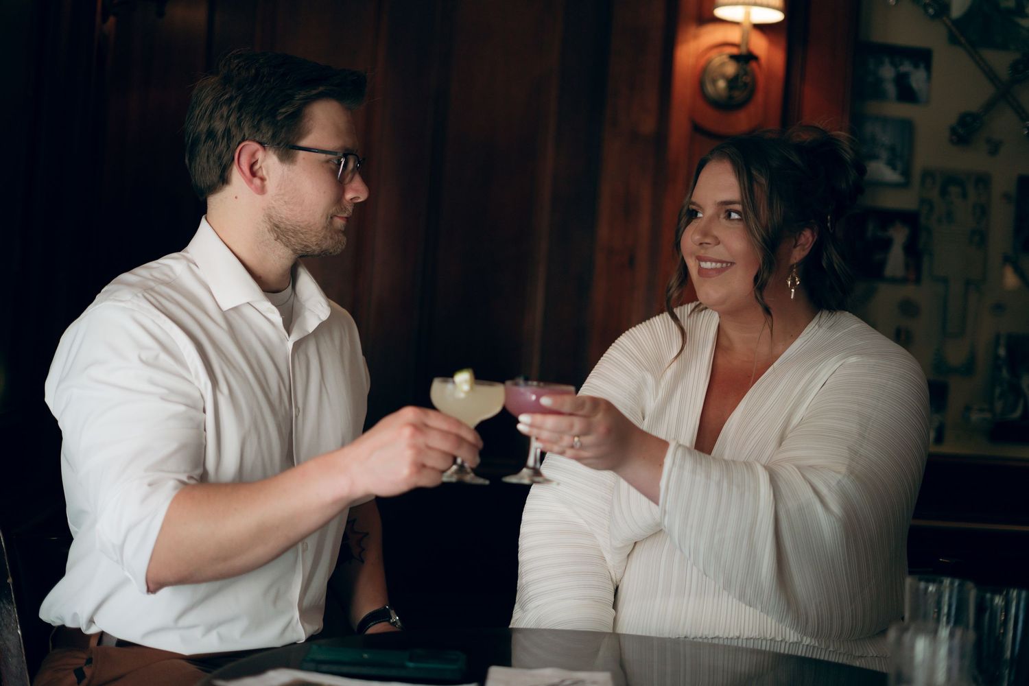 Romantic couple sharing intimate moments in a dimly lit indoor setting.