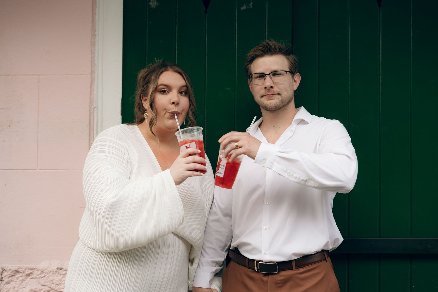 Four candid moments captured of people in white clothing holding red drinks against a dark background.