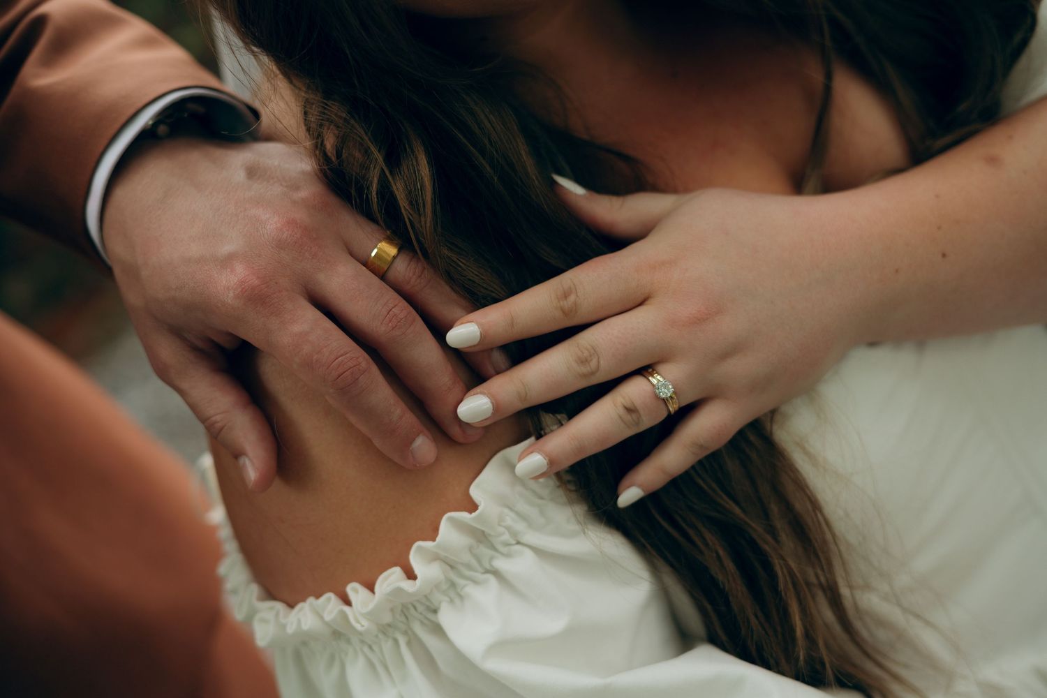 Close-up shots of gentle hand gestures and embraces between a couple during an intimate romantic moment.