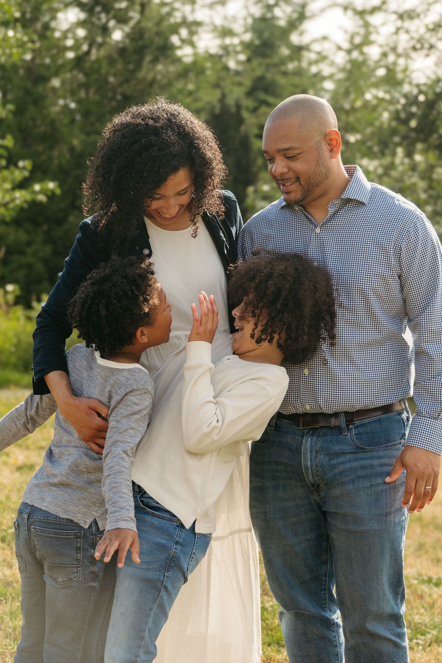 A family enjoying quality time together outdoors in a natural setting during golden hour light.