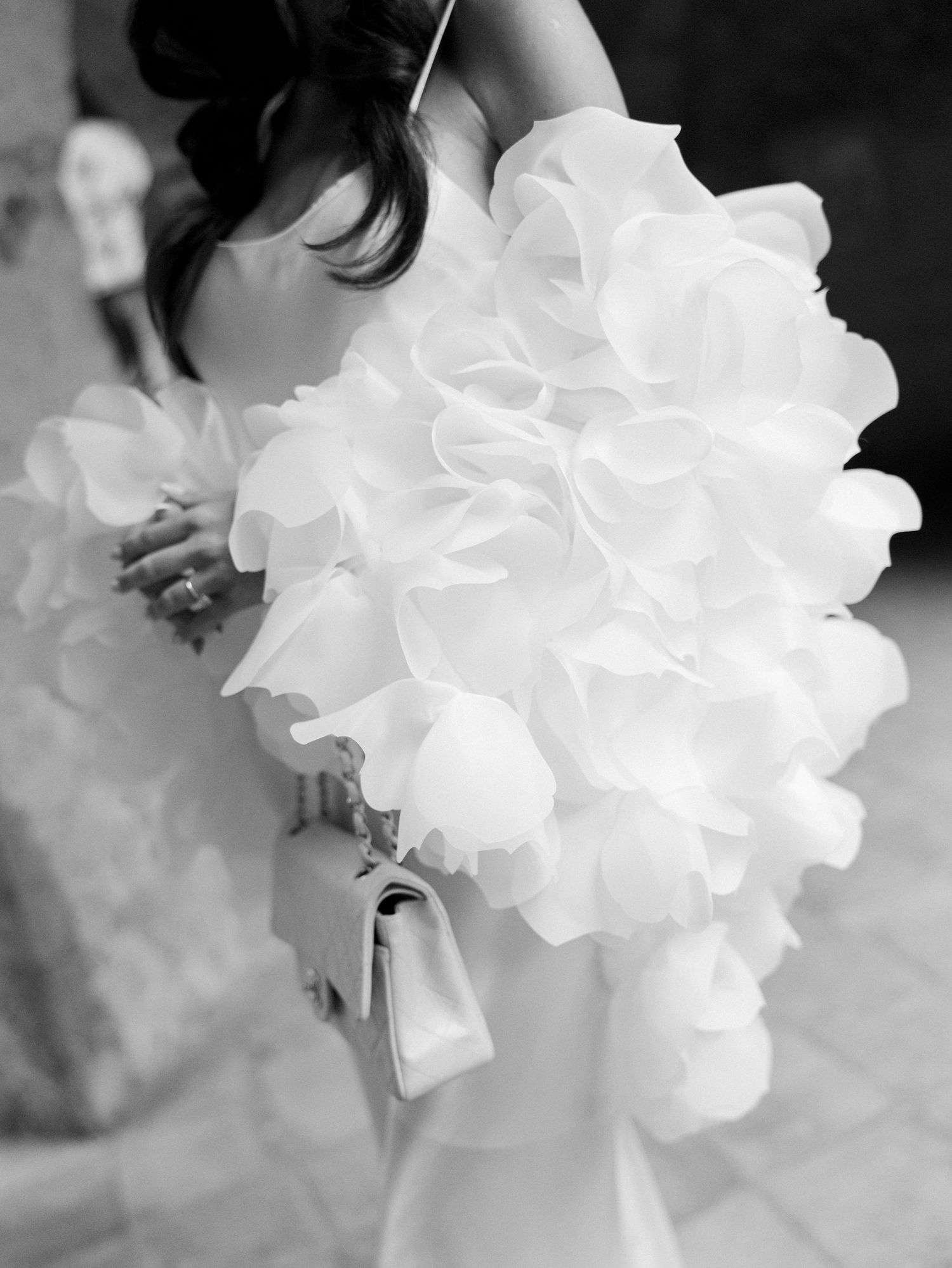 A close-up black and white photograph of delicate white hydrangea flowers in soft focus.