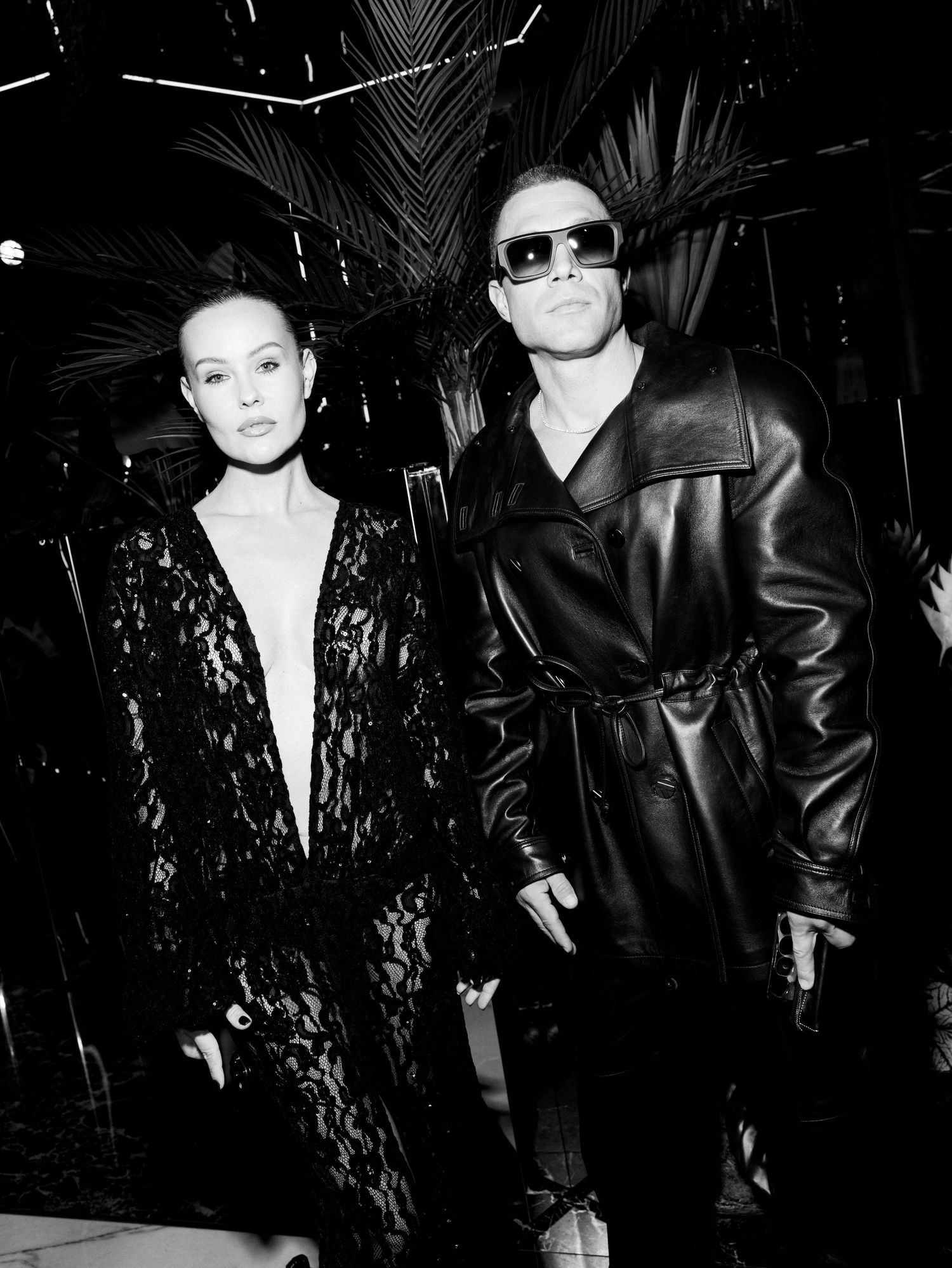 Black and white photo series showing two people in contrasting outfits of leather and lace posing dramatically.