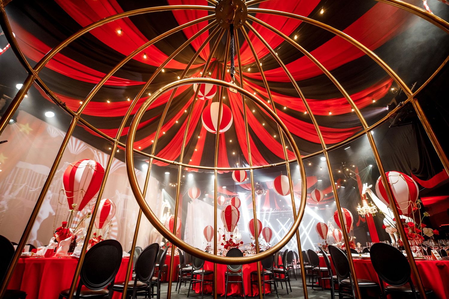Dramatic red and black circular ceiling installation in an elegant dining space.