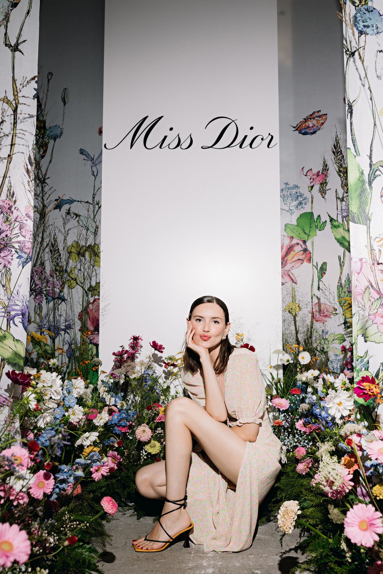 Miss Dior display with floral wall decorations and elegant setting.