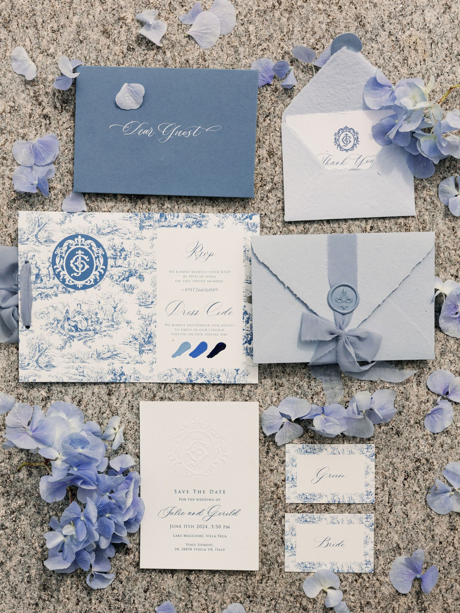 Elegant blue and white wedding stationery suite with toile pattern, wax seal envelope, hydrangea flowers, save the date, and place cards.