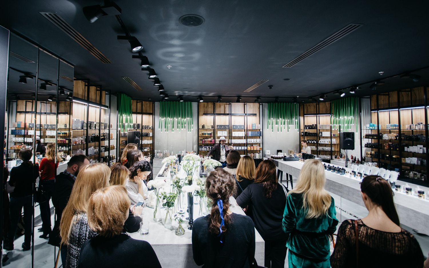 Modern restaurant interior with long tables set for formal dining event.