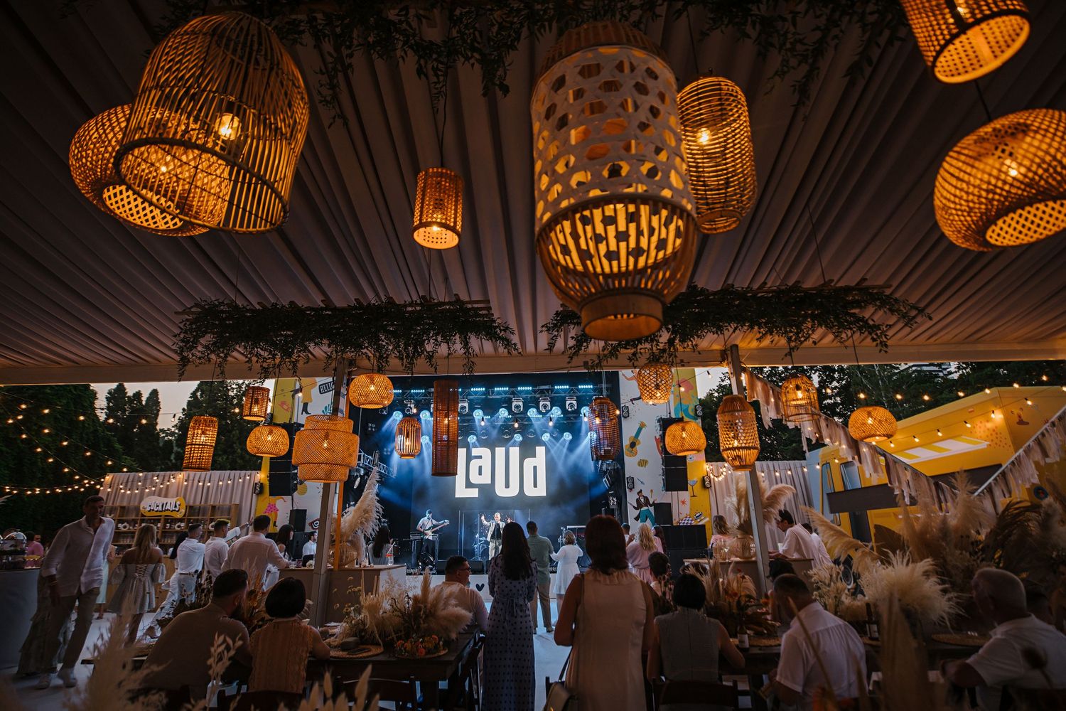 An event space decorated with hanging woven lanterns creating ambient lighting.