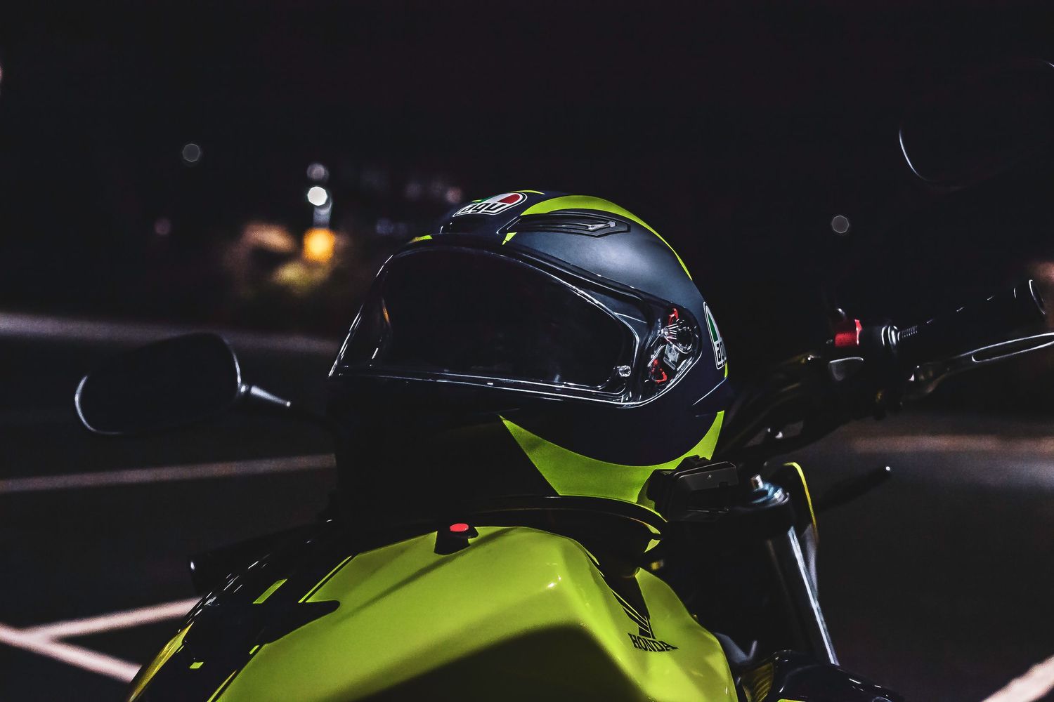 A sleek black and green motorcycle showcases its powerful engine and aggressive styling against a dark background.