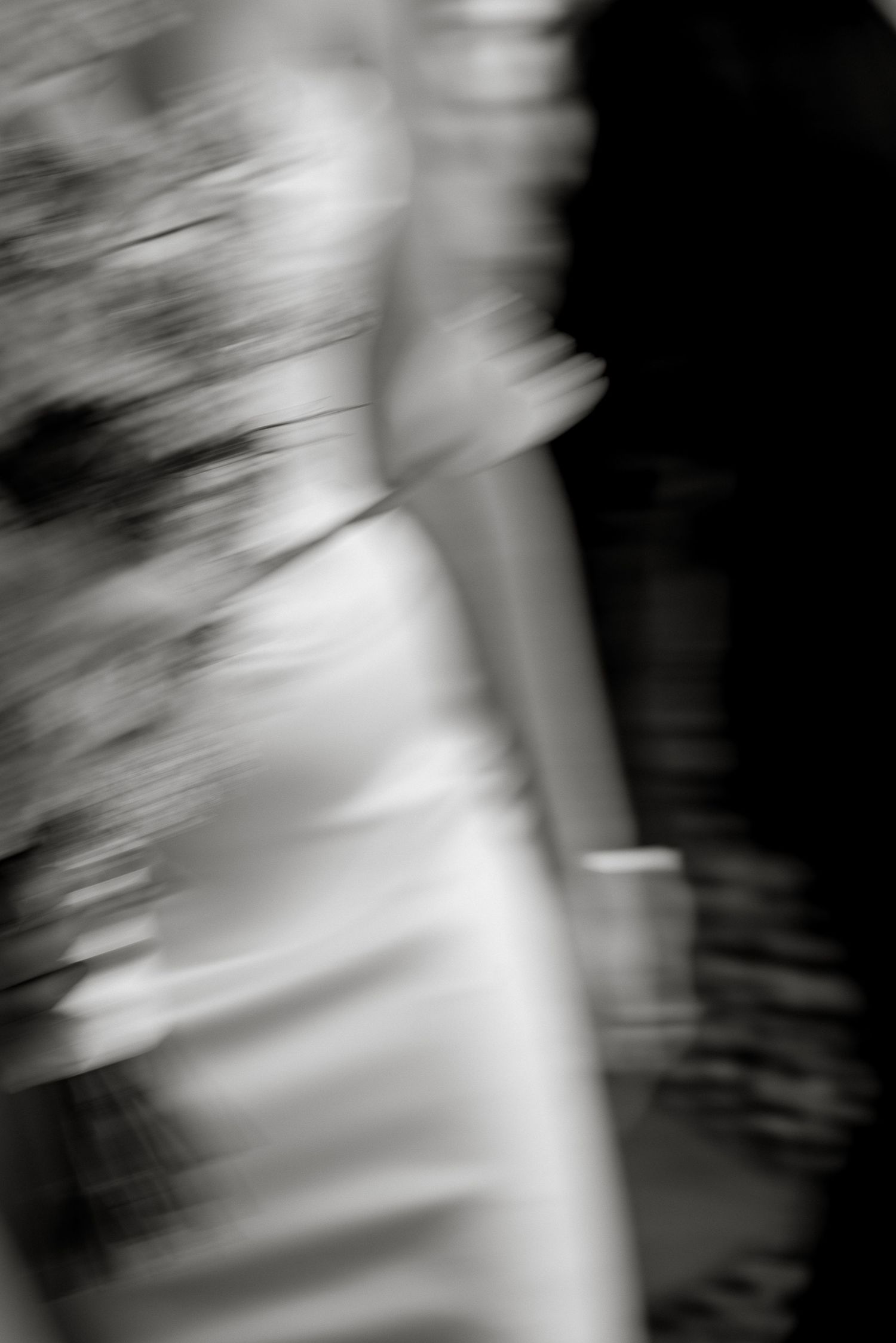 Artistic B&W motion blur of a bridal gown detail at Vocabolo Moscatelli, Umbria. Editorial wedding style.