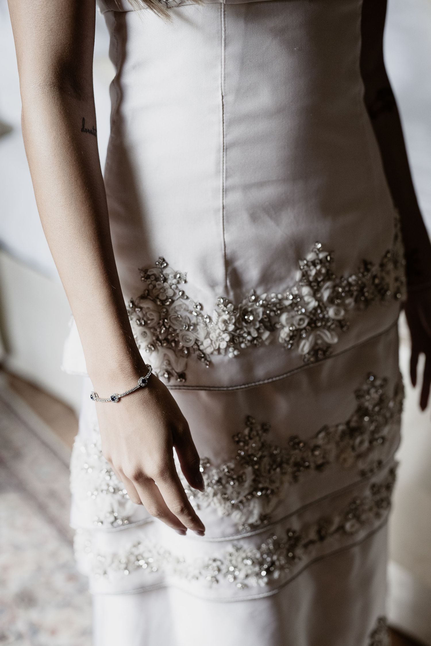 Close-up of a chic, modern bridal gown detail during an elegant wedding at the historic Castello di Celsa in Gradisca d'Isonzo, Italy