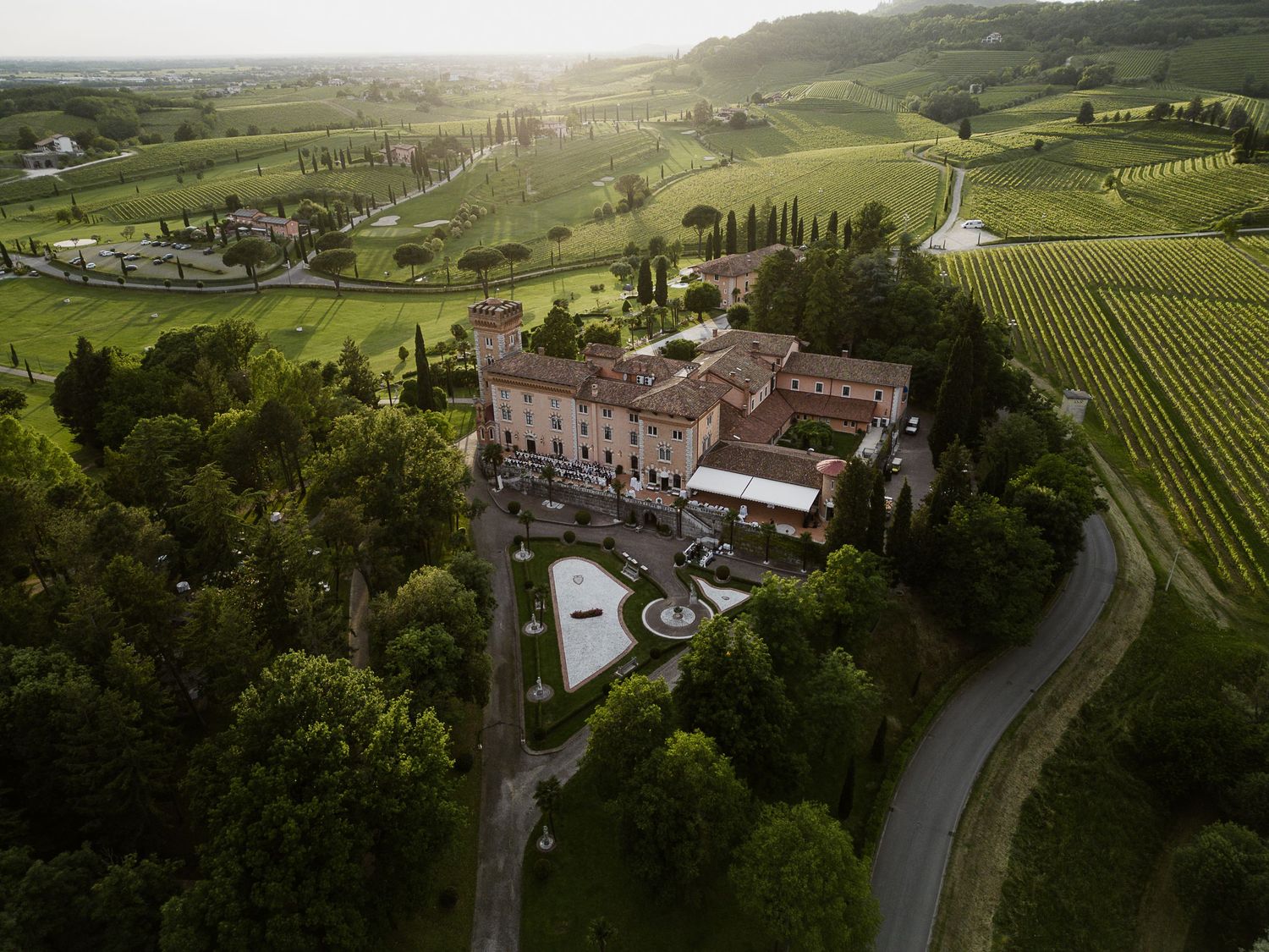 Aerial view of an intimate destination wedding reception at an elegant castle, captured by Gradisca Portento at a luxury Italian estate.