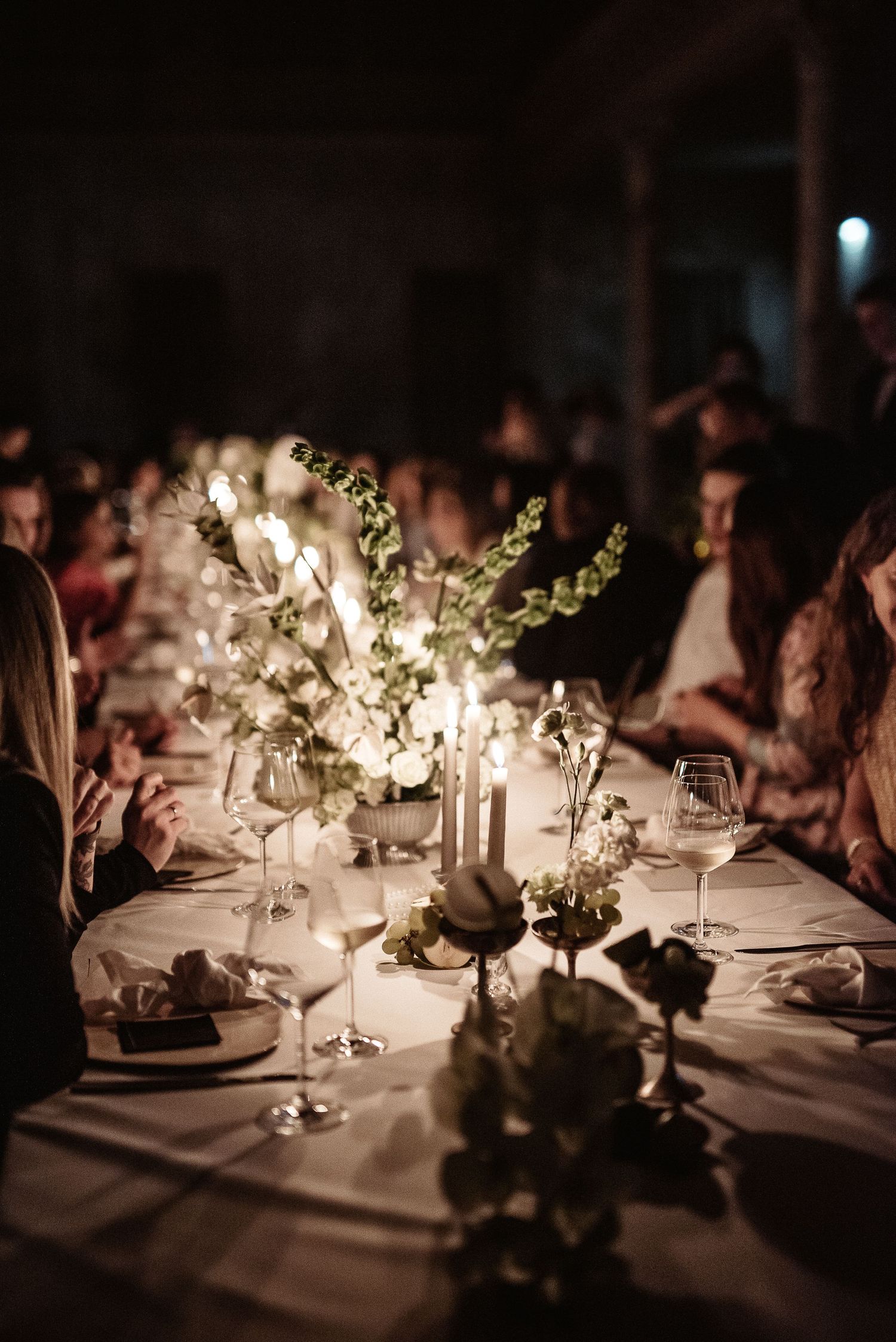 Imperial table with floral decor and candlelight in a Tuscan villa. Elegant destination wedding dinner in Italy.