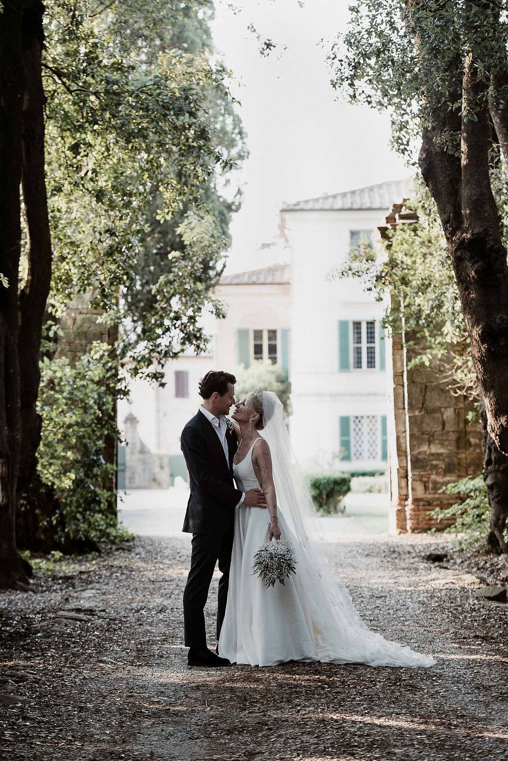 Chic couple portrait in a historic Tuscan garden. Timeless and elegant wedding style by Gradisca Portento.