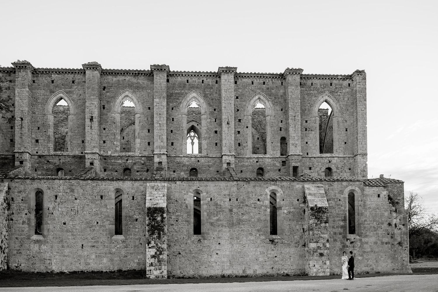 Scenic wedding portrait at the roofless Abbey of San Galgano. Luxury boutique photography for international destination weddings in Tuscany