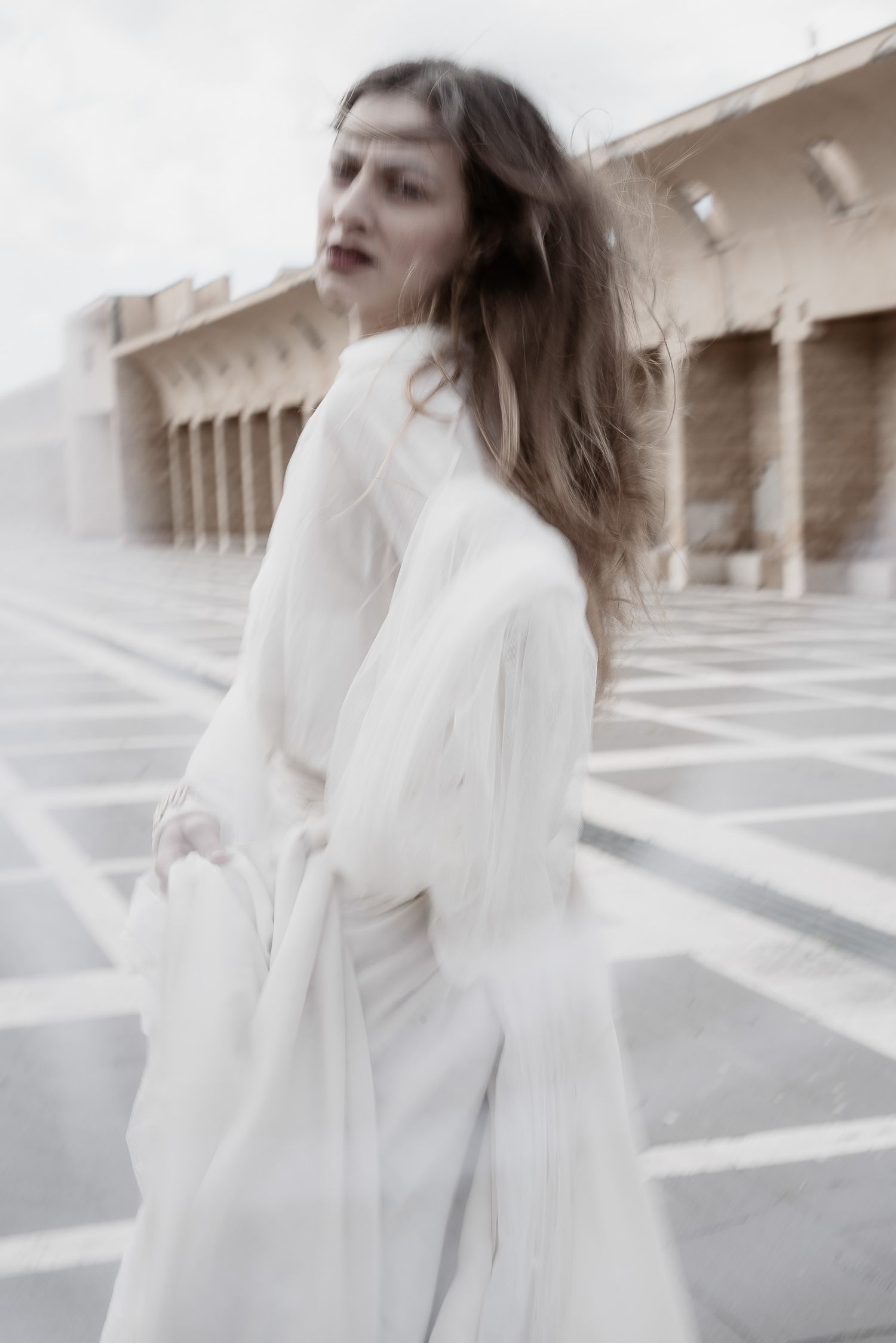 Modern bride in motion during an editorial portrait session in Siena. Dynamic and chic Italian wedding style.