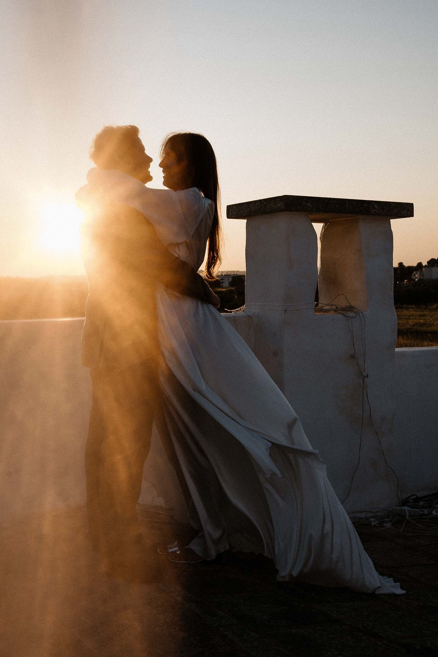 Candid sunset embrace at Masseria Torre Coccaro, Puglia. Authentic couple portrait by Gradisca Portento.