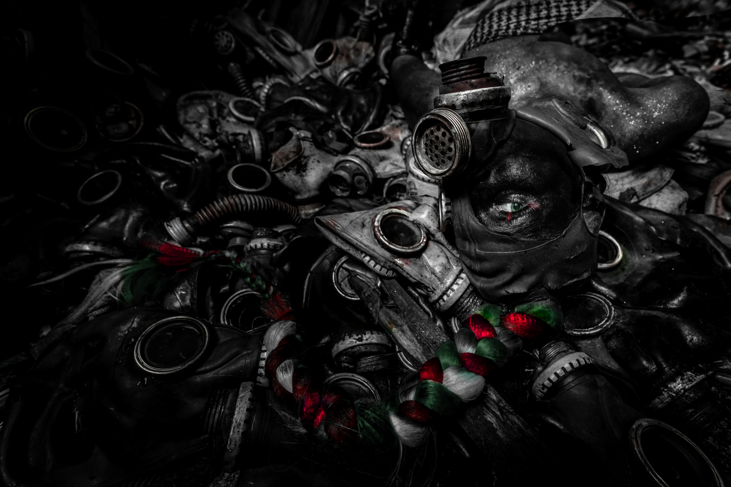 Abstract dark metallic artwork with glowing red and green accents creating a dynamic mechanical pattern.