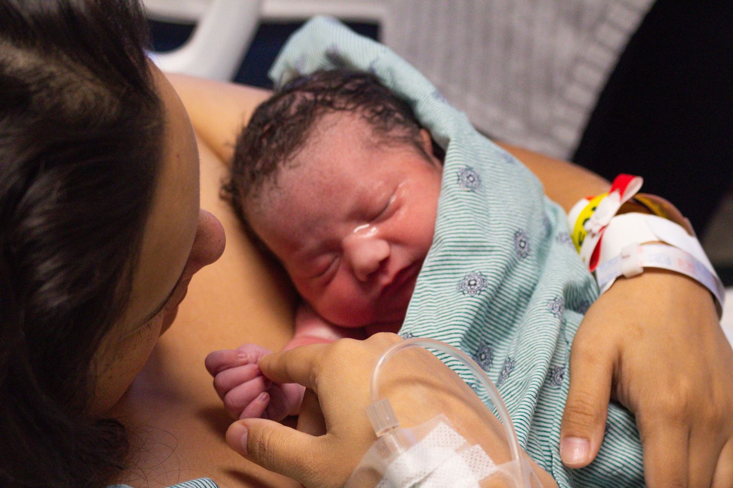 Newborn baby crying during first moments after birth.