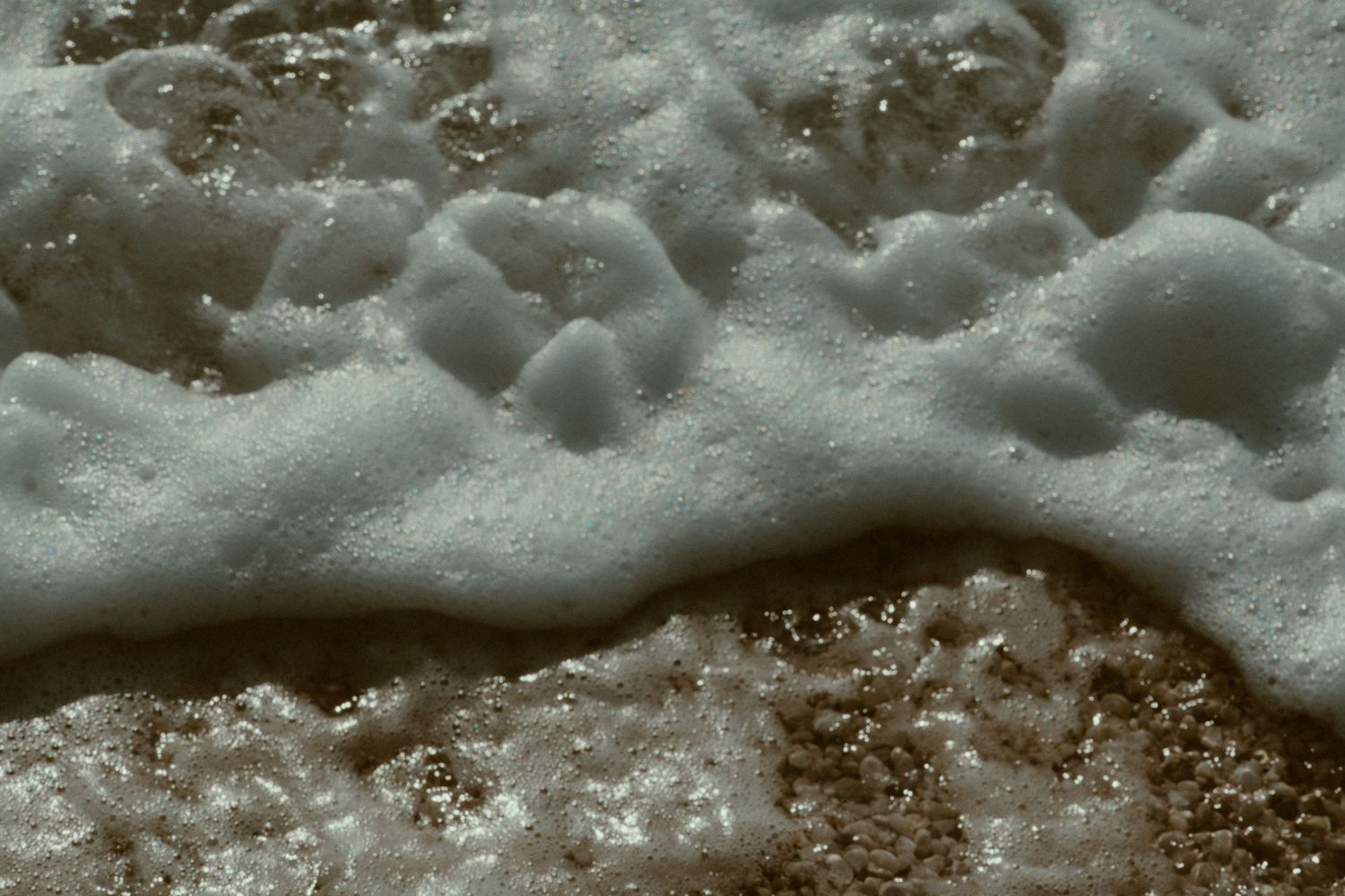 Abstract macro shot of soap bubbles and foam creating a textured pattern.