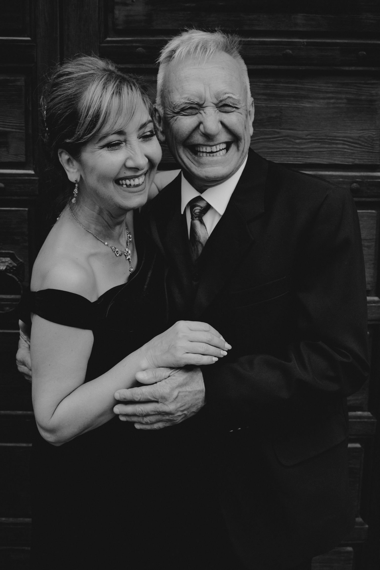 Black and white portraits capturing joyful laughter and intimate moments between a couple.