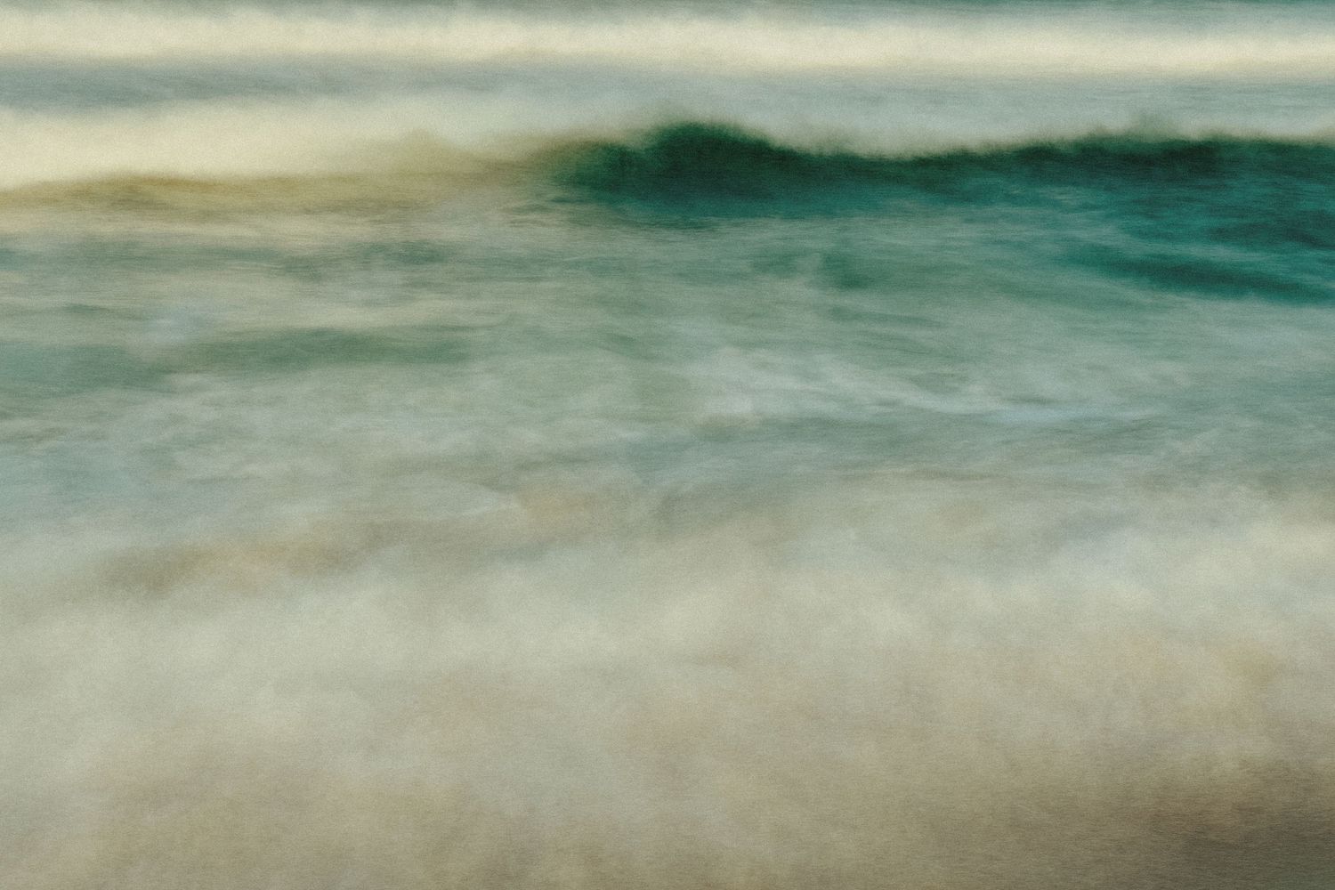 Abstract seascape with blurred turquoise waves and sandy beach.
