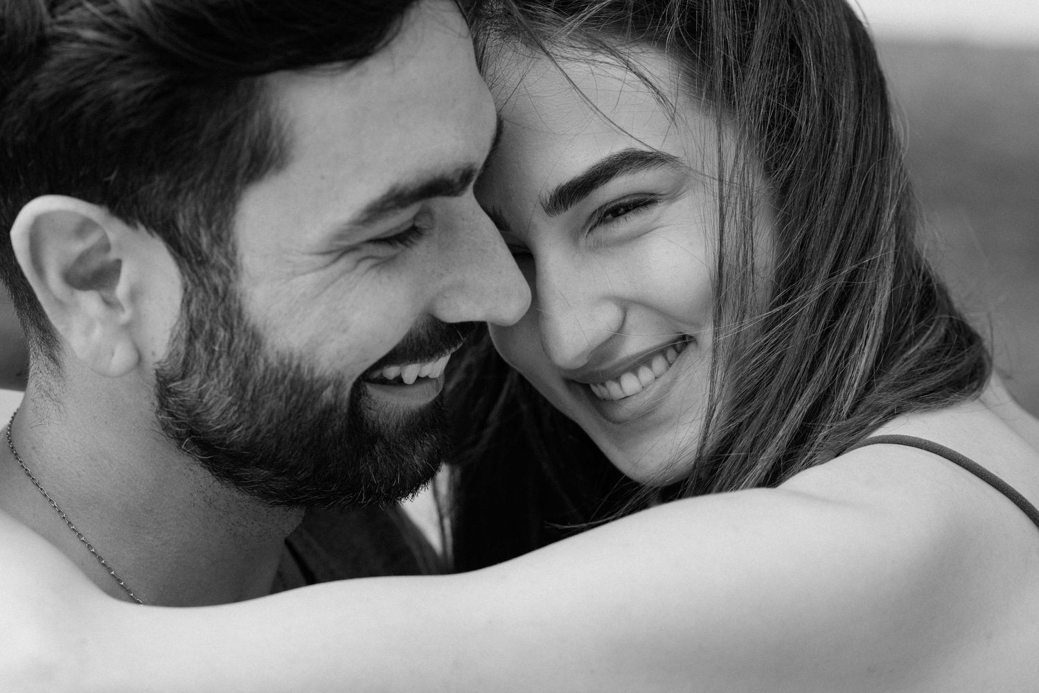 A tender black and white moment of intimate laughter and joy between a couple.