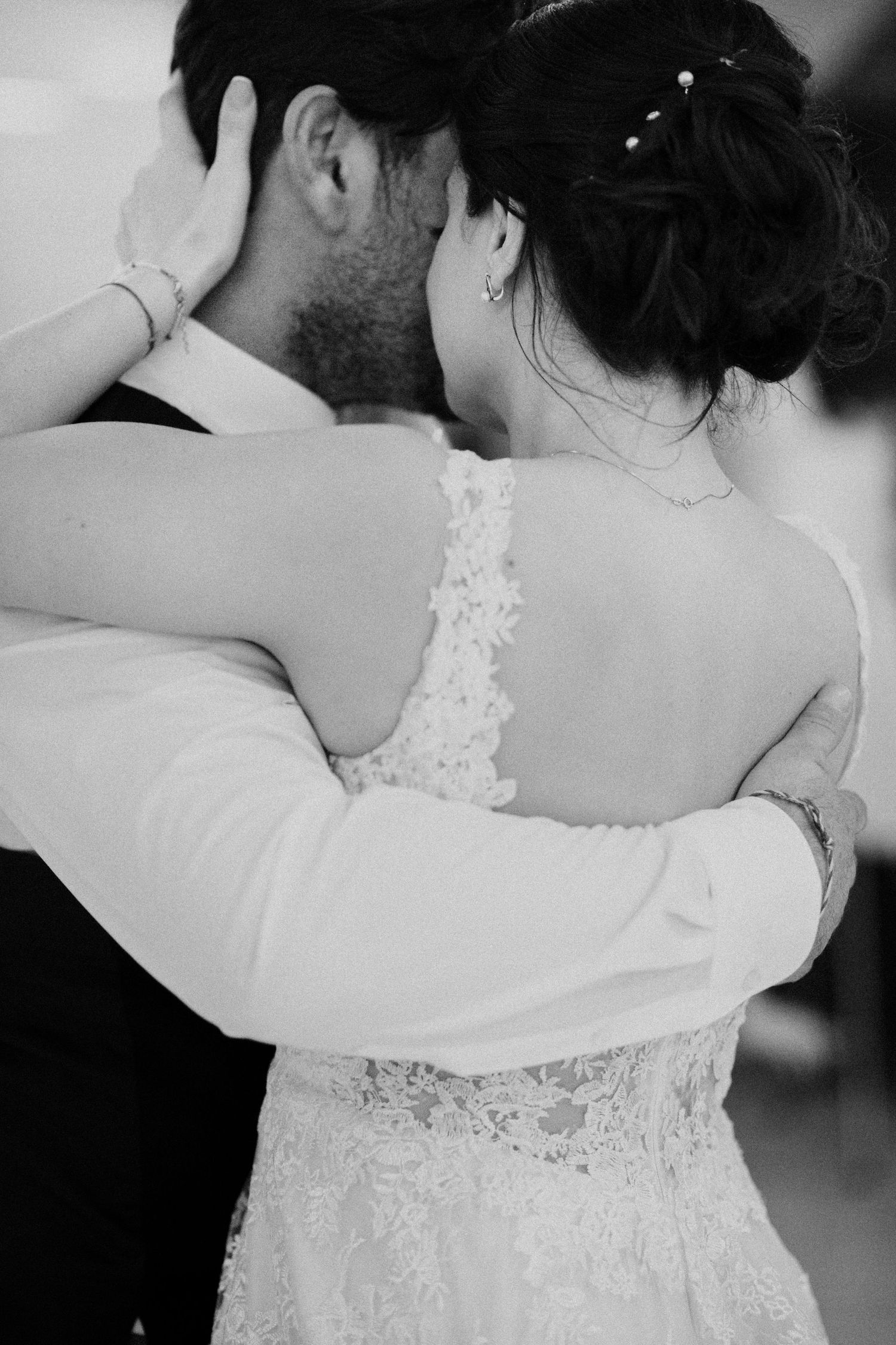 Black and white intimate moment of newlyweds embracing during their first dance.
