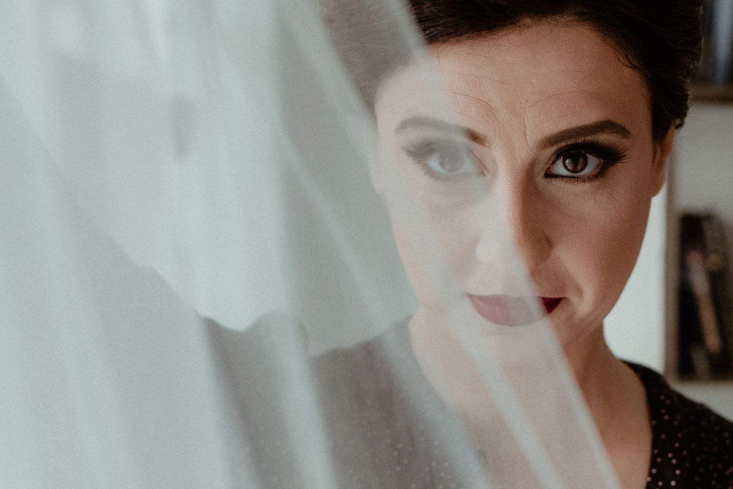 Ethereal bridal preparation scene with soft lighting and white tulle details.