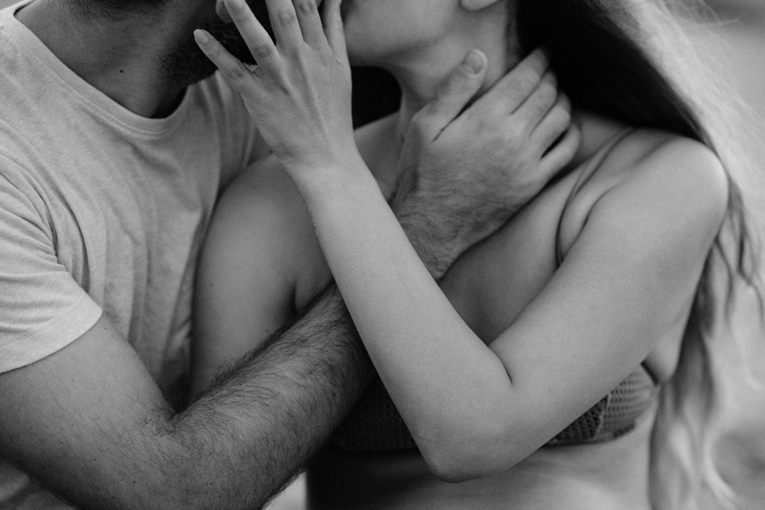Intimate black and white photograph capturing a tender moment between two people.