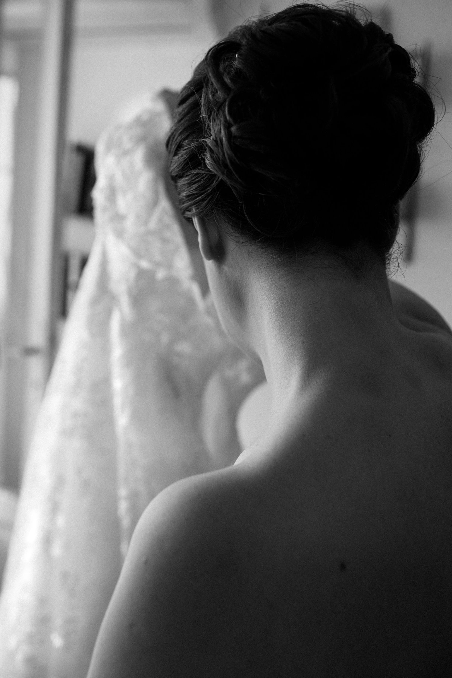 A series of soft, dreamy black and white photos showing bare shoulders and delicate lace details.