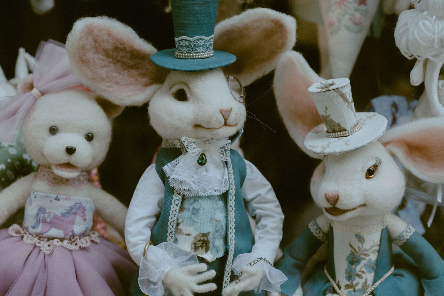 Vintage-style stuffed bunny and bear decorations wearing fancy dress clothes and top hats.