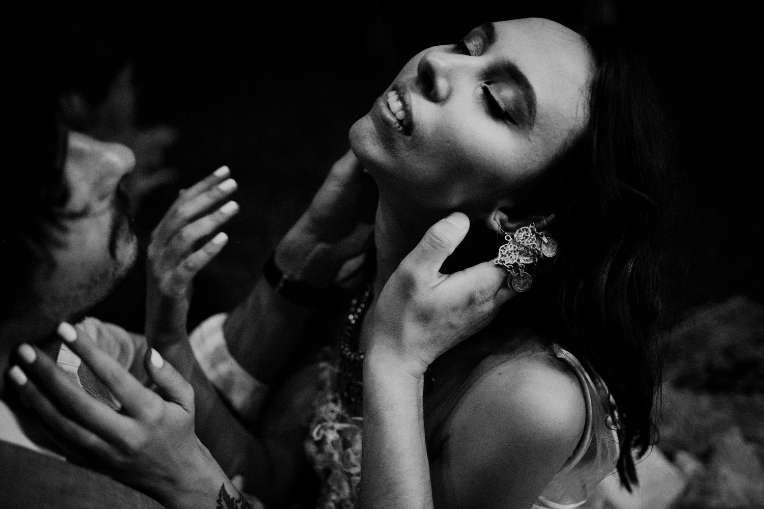 Dark intimate party scene with shadow silhouettes and dramatic lighting.