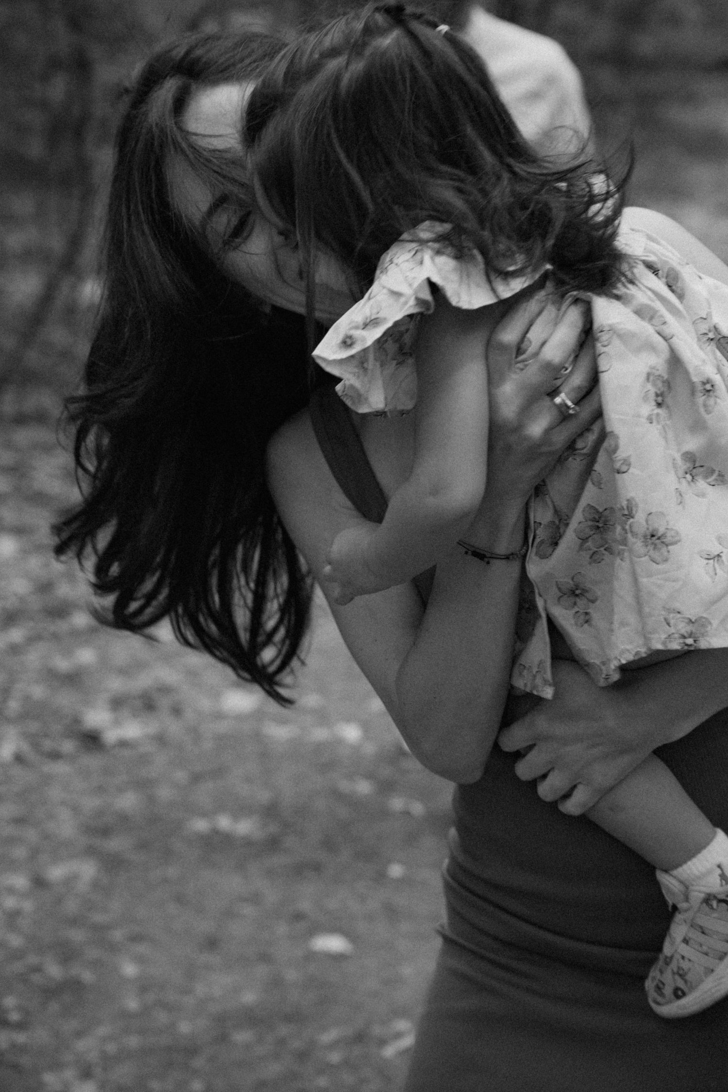 A black and white artistic photo series showing a person in emotional turmoil hugging themselves with head bowed down.