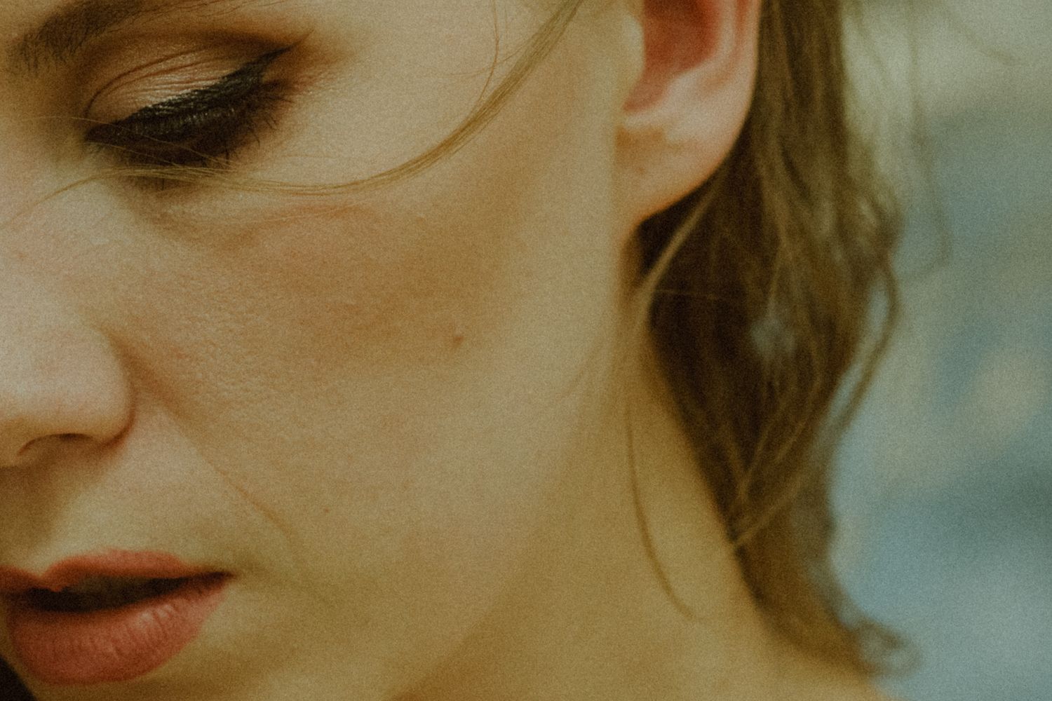 An artistic macro shot showing the side profile with soft focus on the eye and cheek.