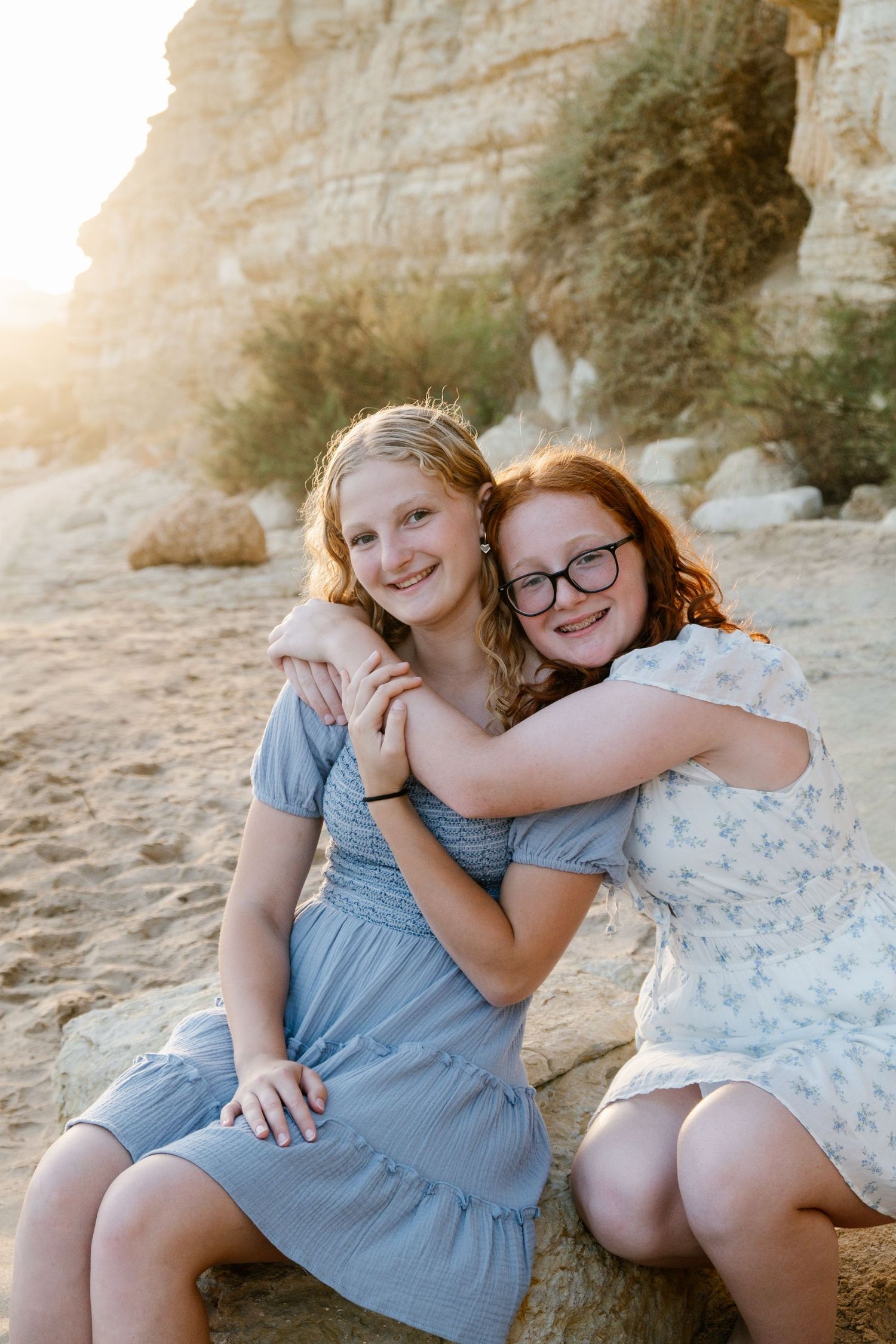 playful hug between two sisters at the beach during golden hour in Lagos