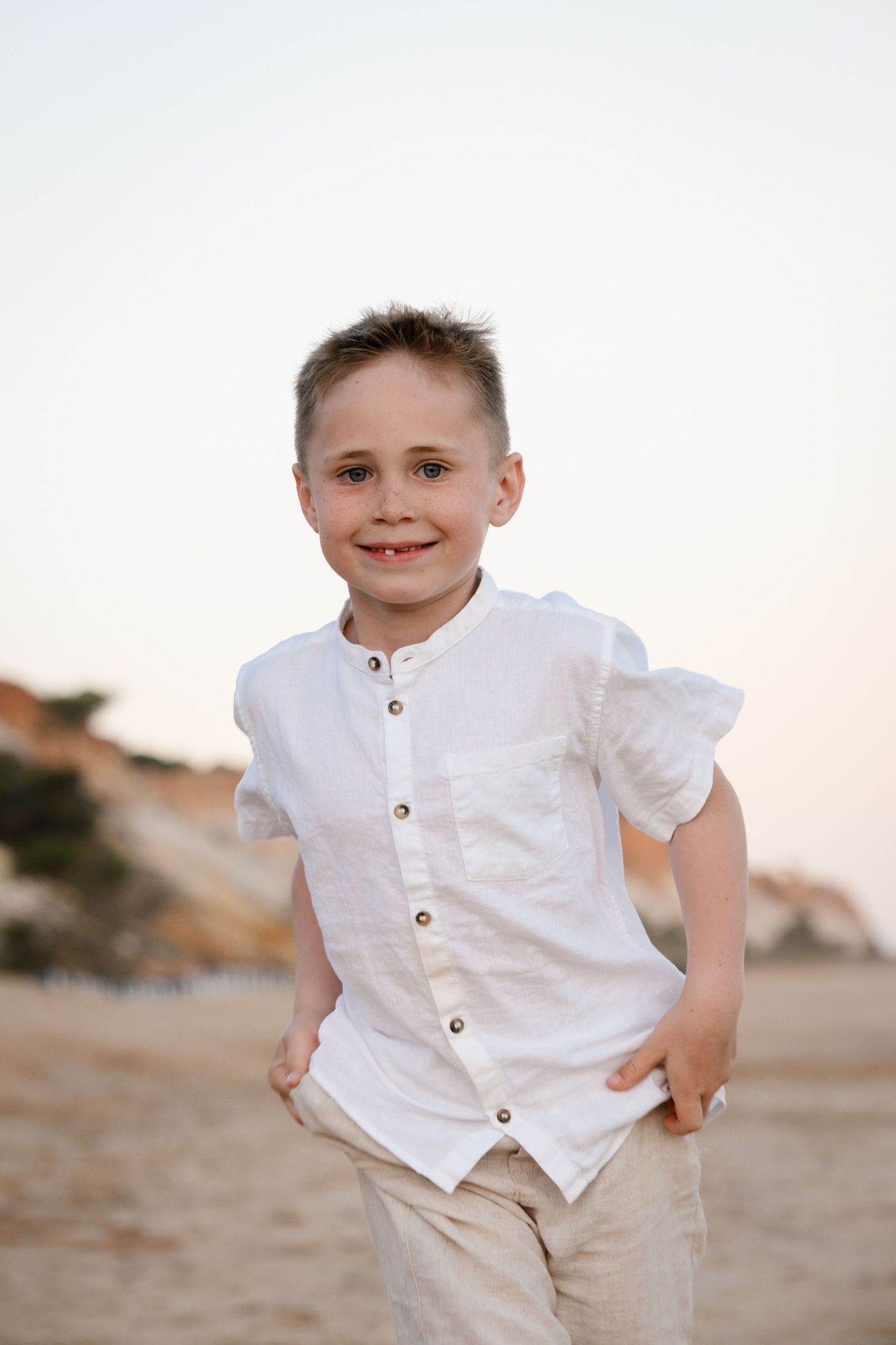 kid is running on the beach during sunset