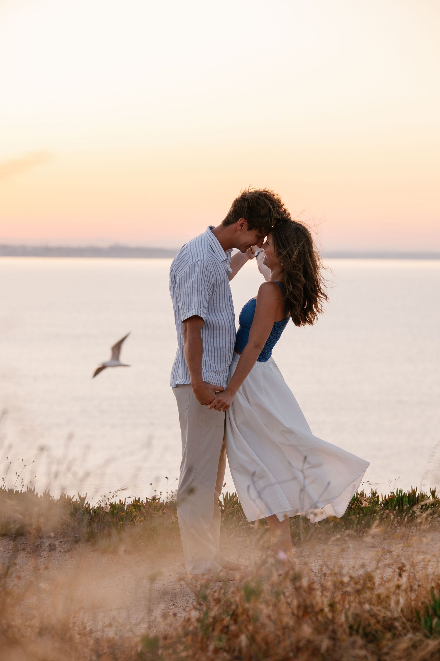 Beautiful couple holding hands on top of the cliff at prairie do camilo