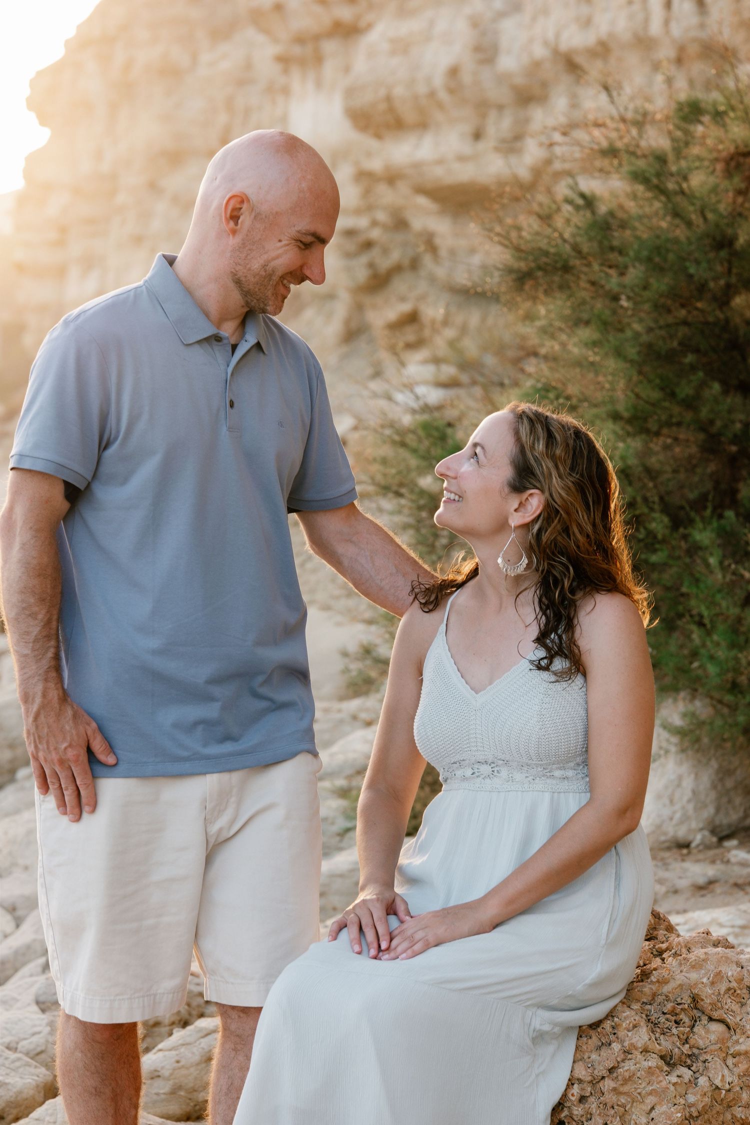 romantic moment of parents leaning forehead to forehead on Porto de Mós beach