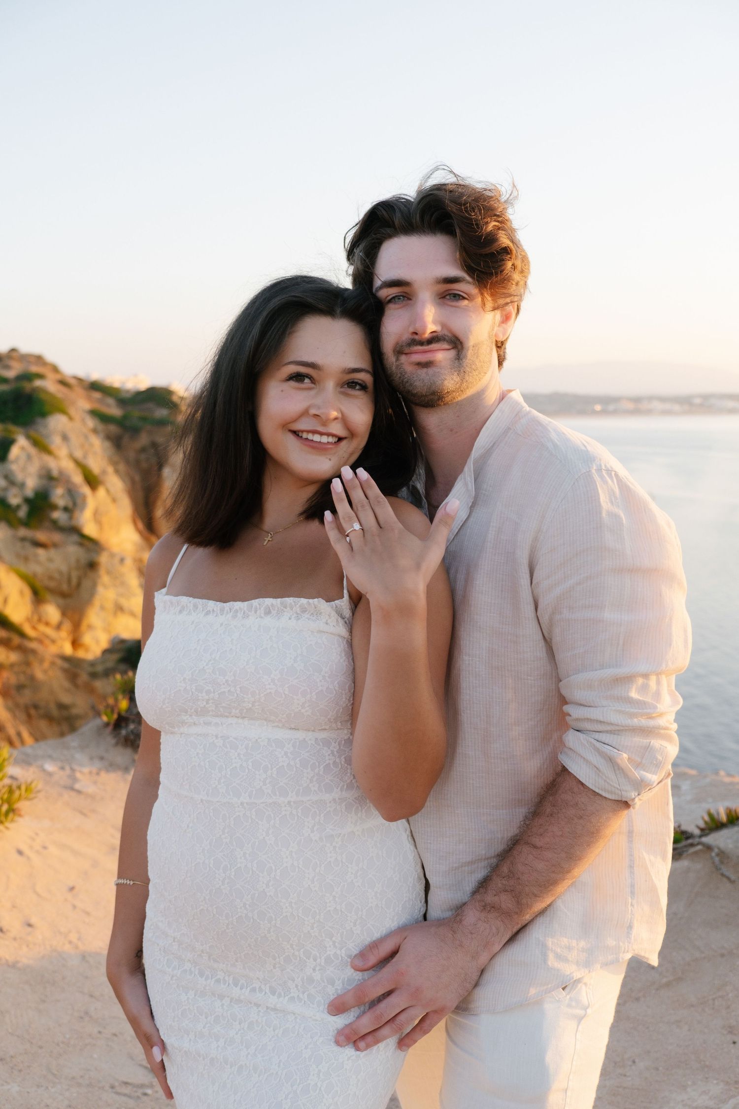 proposal on cliff viewpoint with golden Lagos rock formations in background — professional proposal photographer in the Algarve