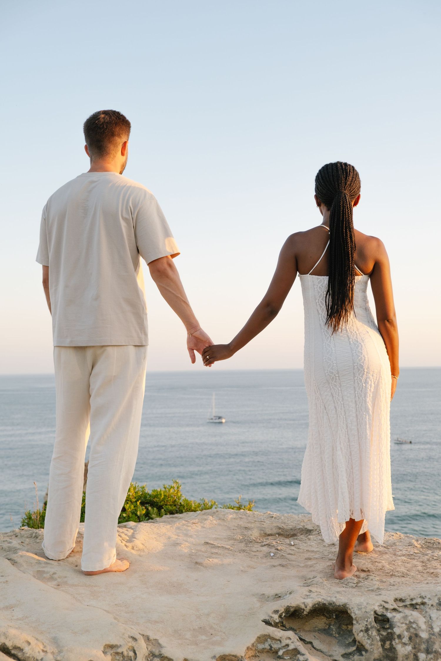 cliff view with couple standing watching the ocean