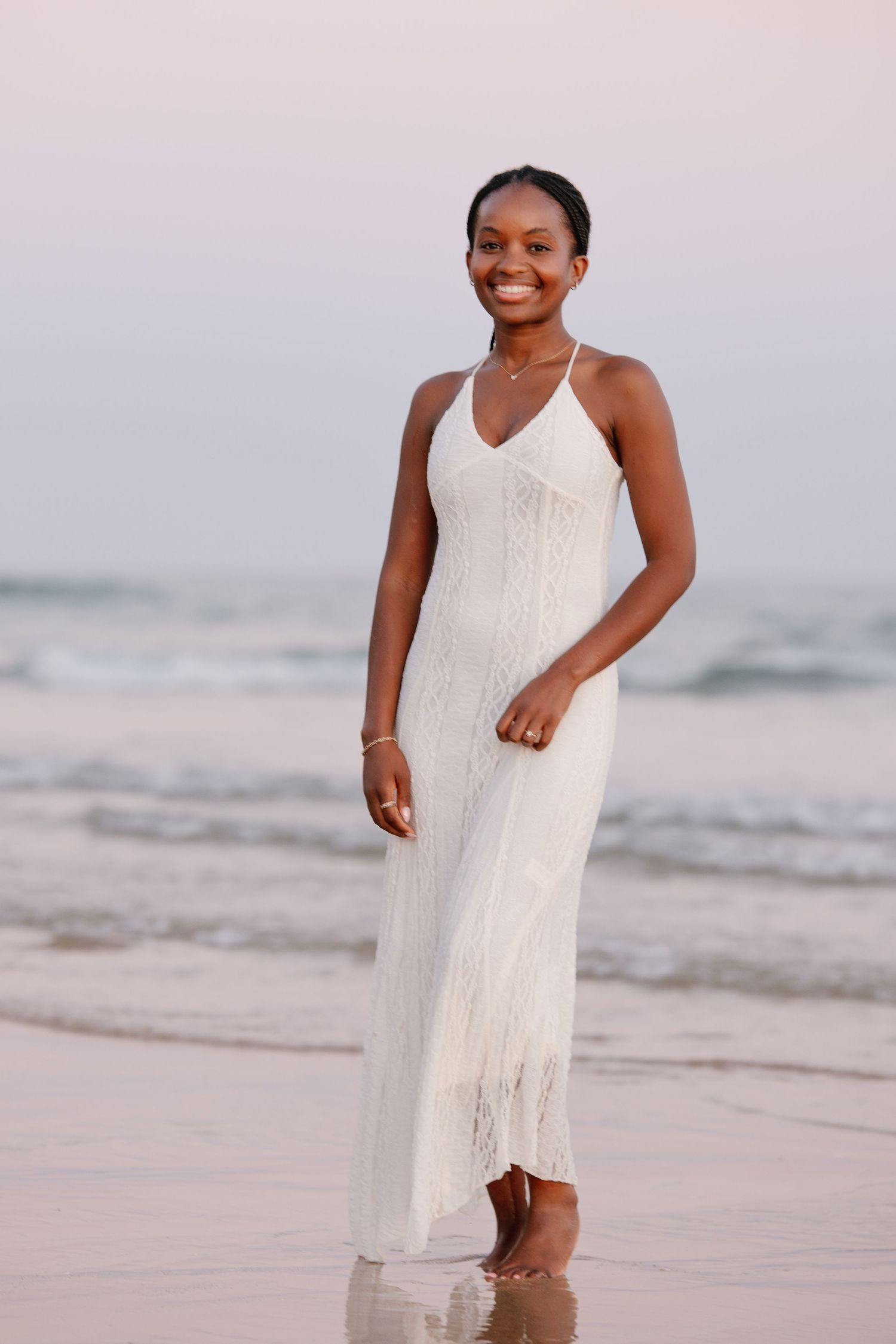 woman standing with white dress smiling to camera