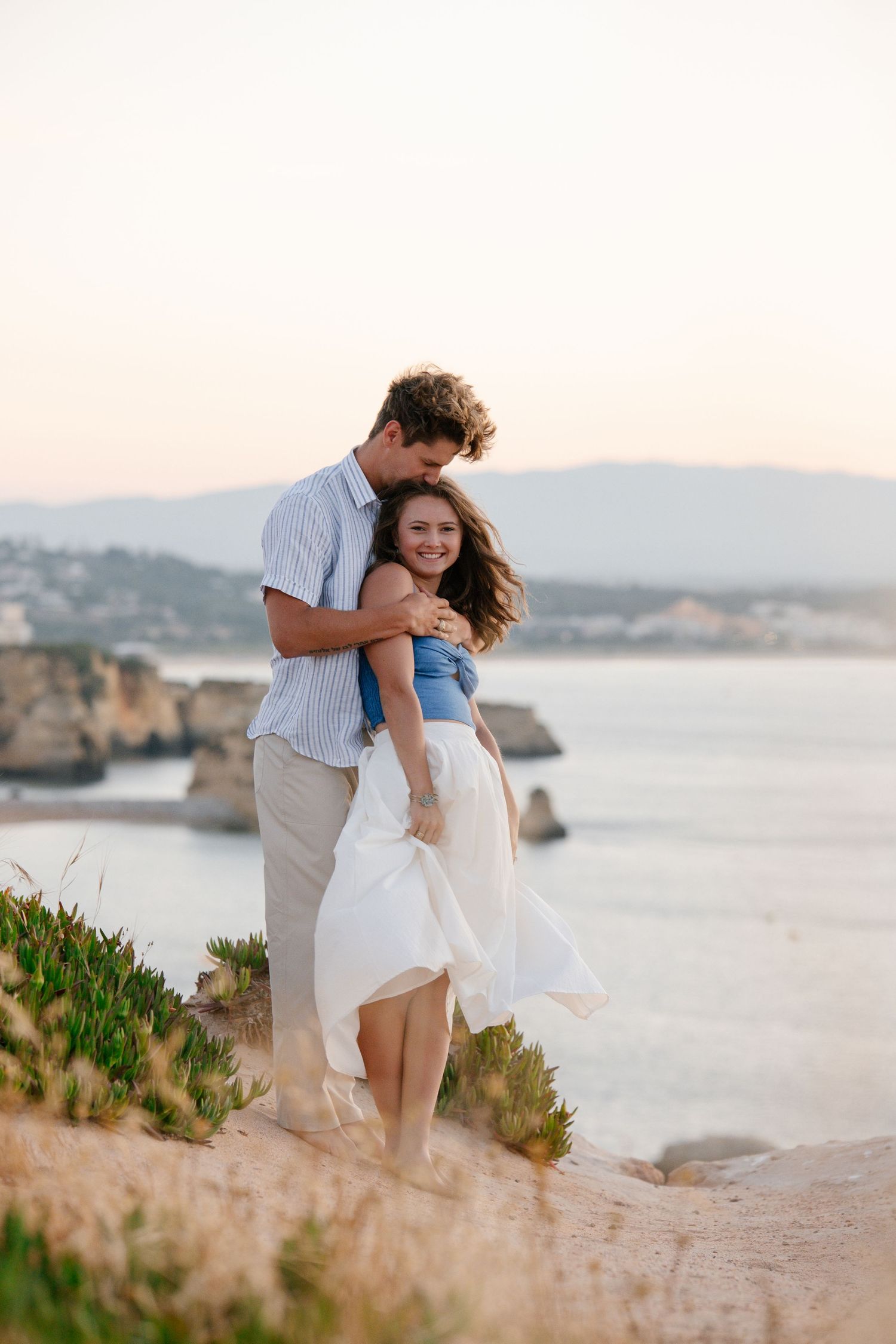 Couple standing at a beautiful viewpoint on the cliffs of lagos