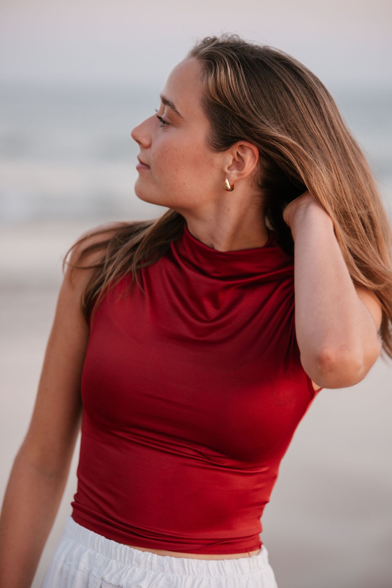 soft golden close-up of girl at sunset on the beach with warm light on her face