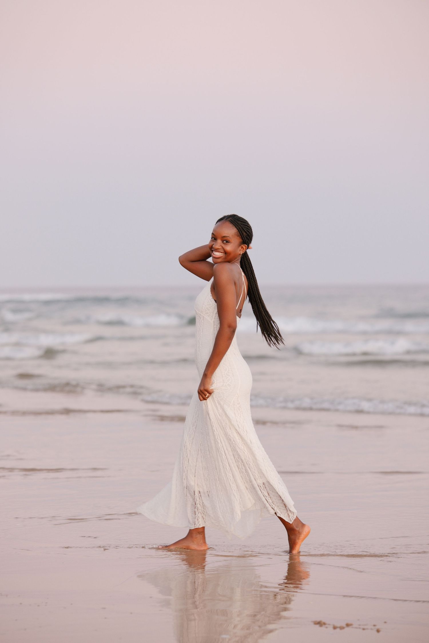 Portrait with black woman with white dress on the beach