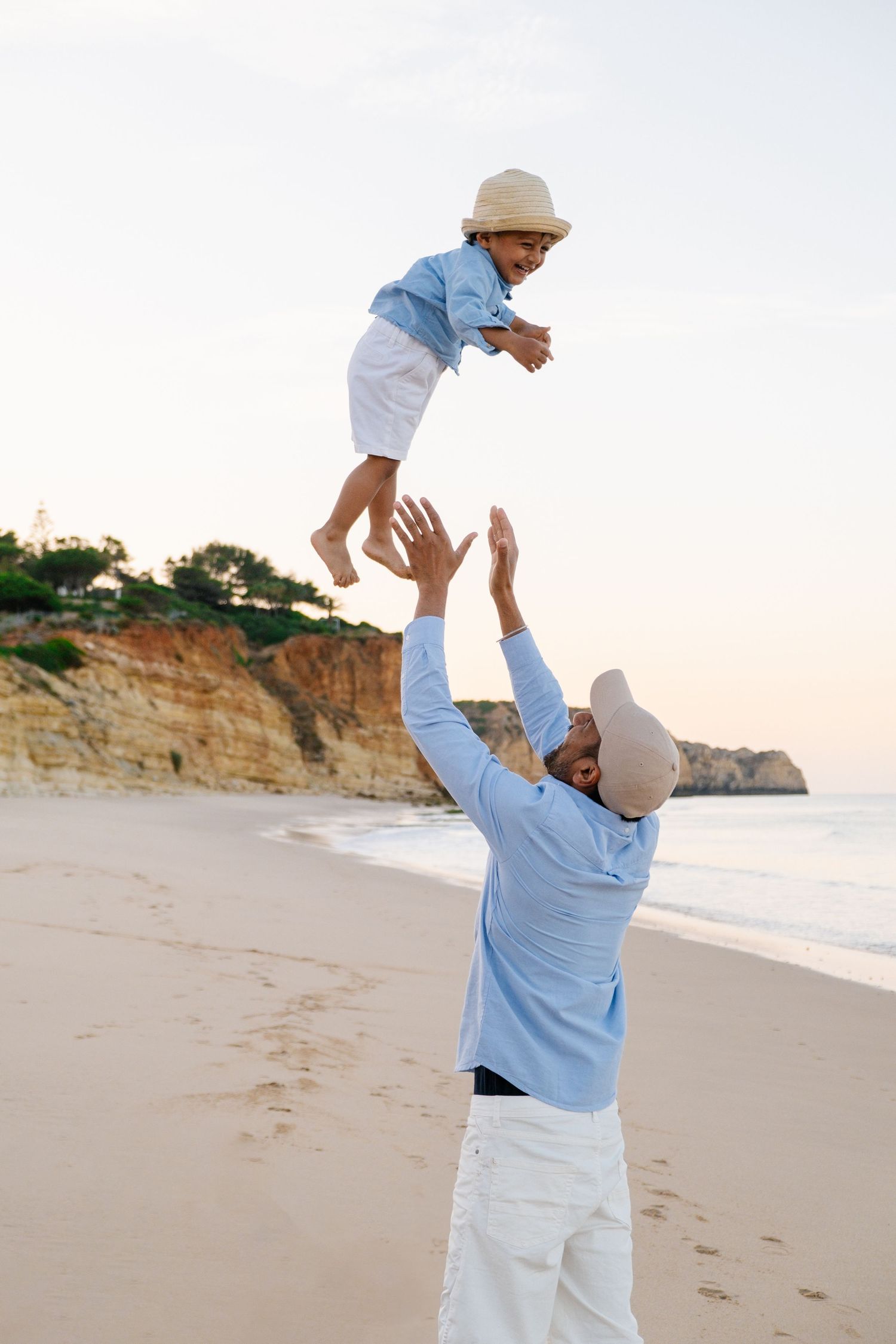 father is throwing his son in the air during a beautiful sunset photoshoot in Lagos