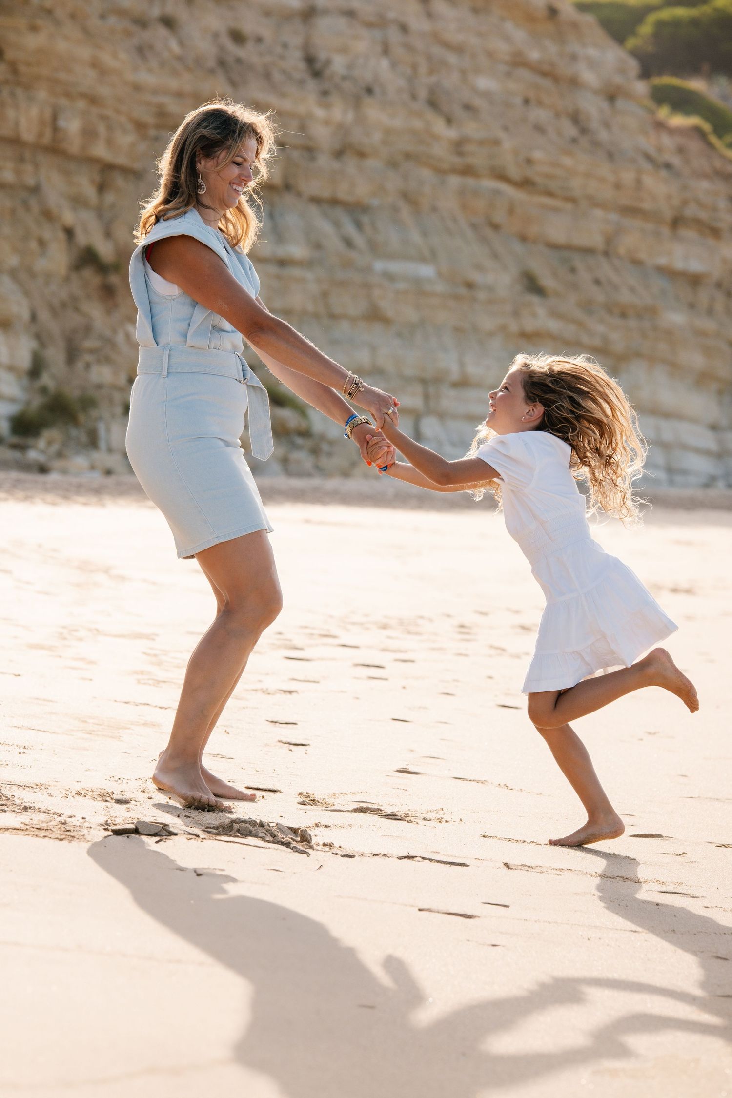 Mom and daughter playing on the beach