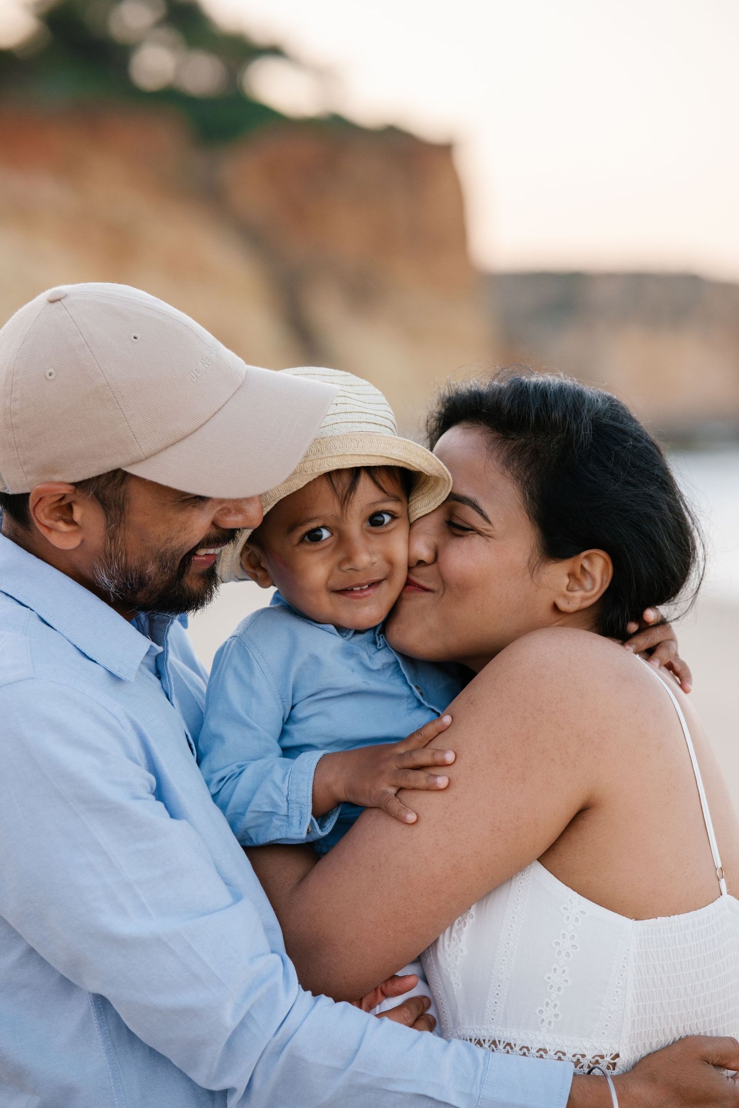 parents hugging son with big love