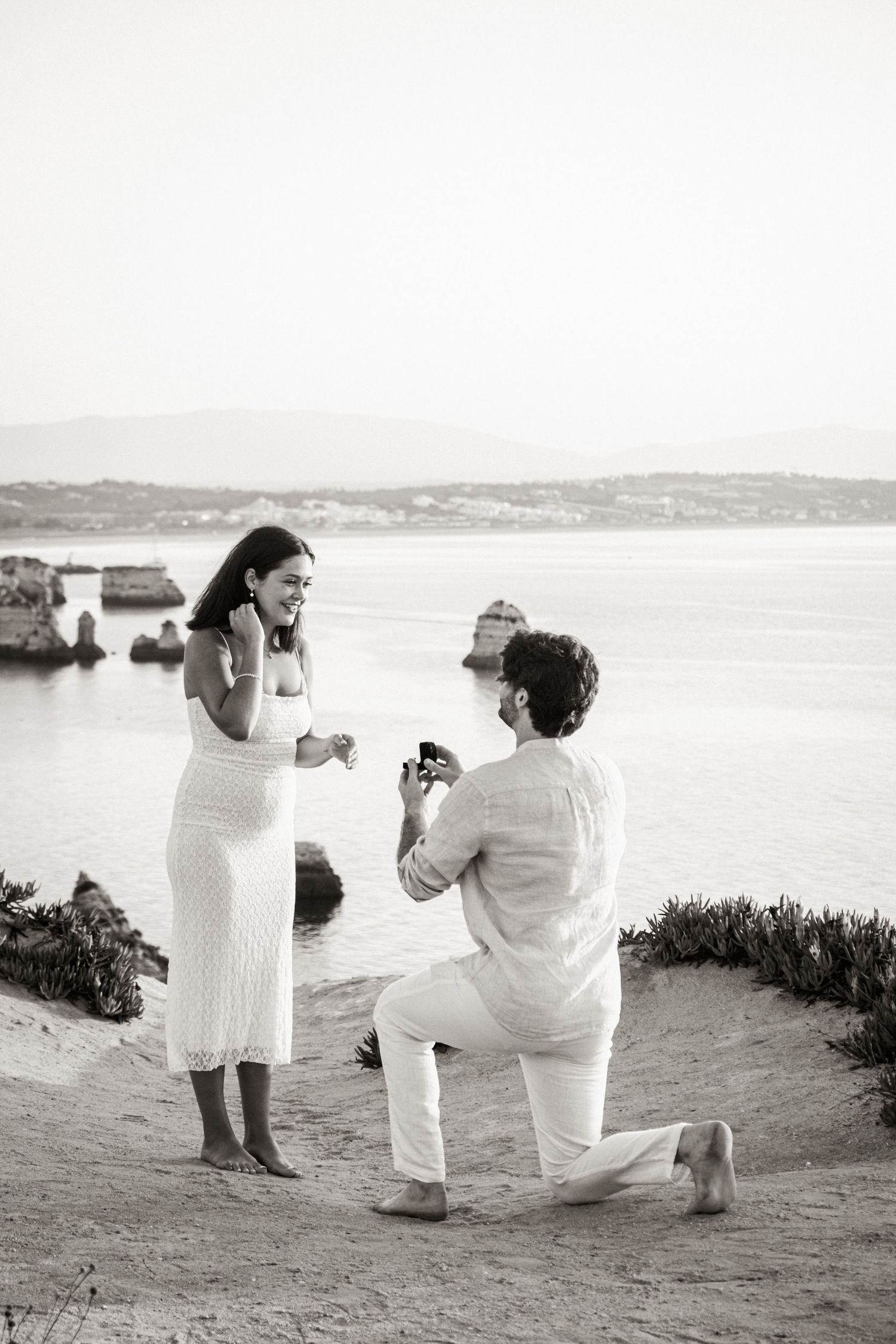 surprise proposal at dawn with dramatic coastal cliffs of Lagos behind the couple — Algarve proposal session