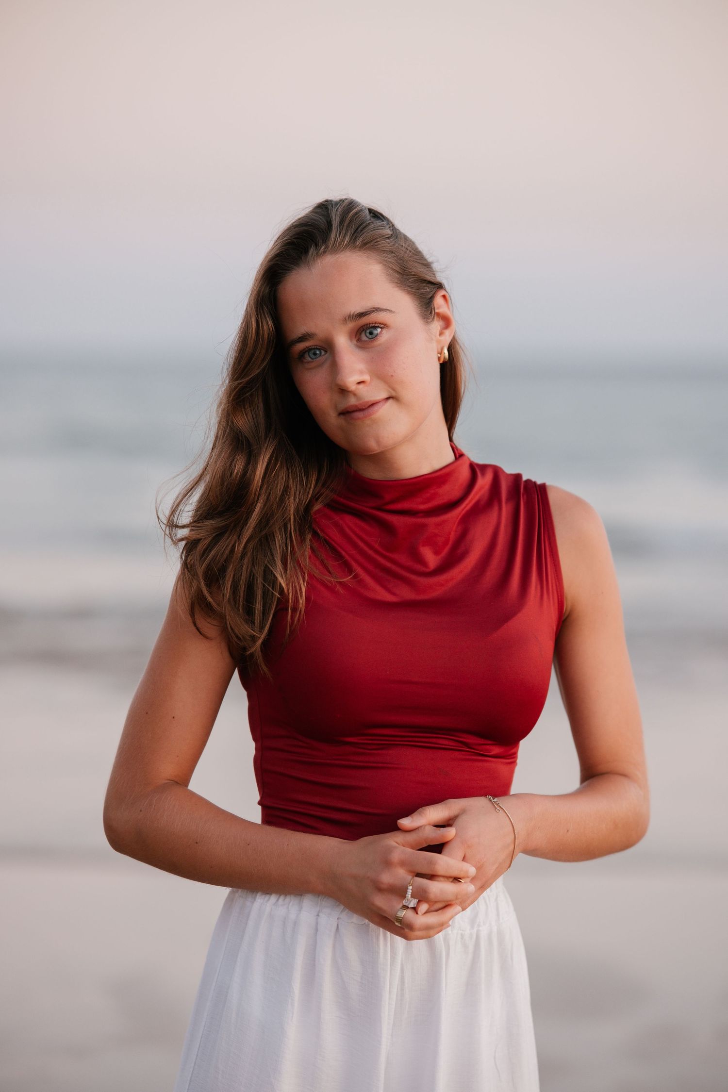 intimate close-up of girl looking into the camera at Três Irmãos during sunset